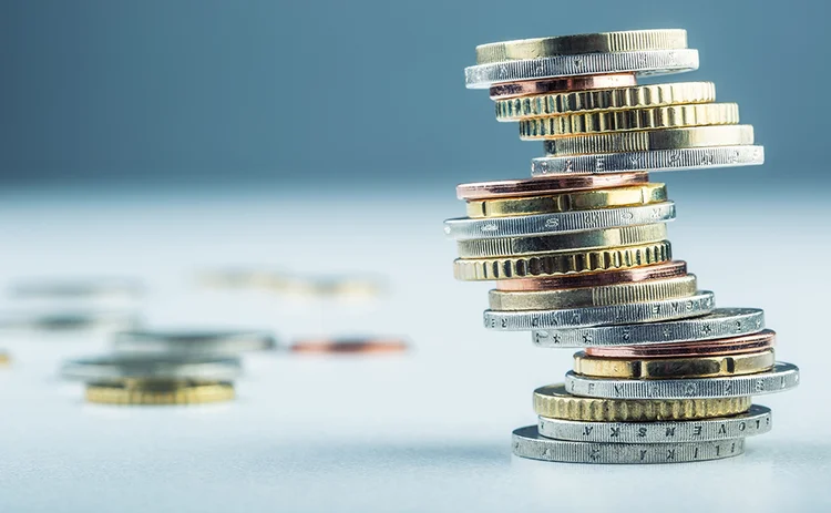 a precarious stack of euro coins