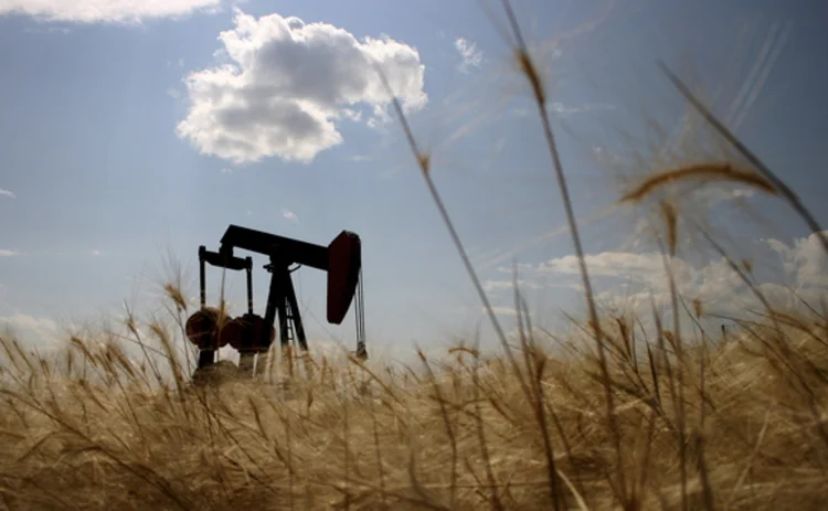 oil-rig-silhouetted-in-wheat-field